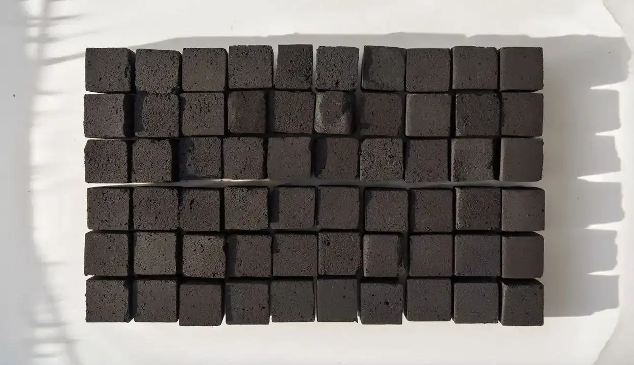 coconut charcoal cube uniform shape arranged in neat rows on white
